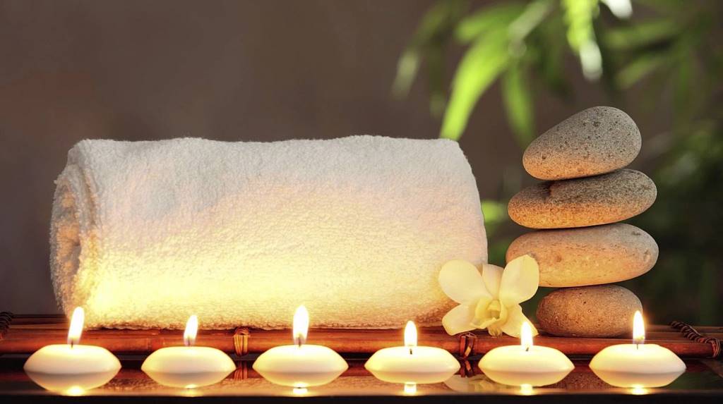 spa candles and towel